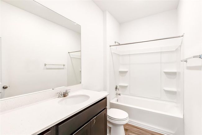 Bathroom with vanity, toilet, shower / bath combination, and wood finished floors | Image 20