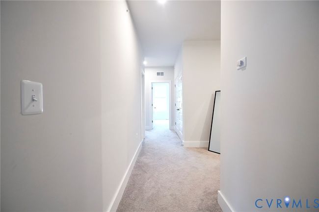 Hall featuring light carpet and baseboards | Image 14