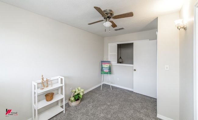 Carpeted spare room with a ceiling fan, baseboards, and visible vents | Image 20