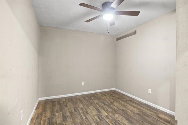 Empty room with wood finished floors and ceiling fan | Image 16