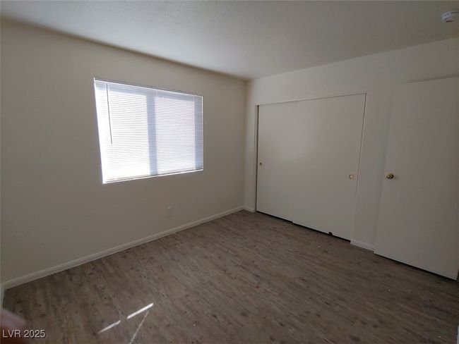 Unfurnished bedroom with a closet and wood-type flooring | Image 10