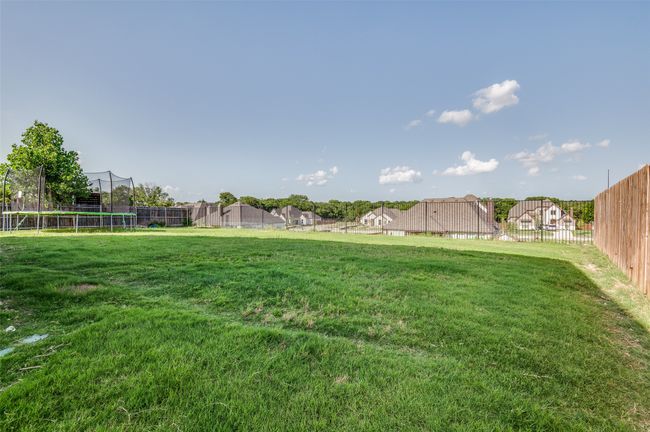 View of yard with a trampoline | Image 25