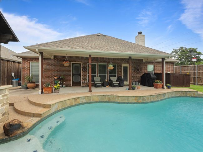 View of swimming pool featuring area for grilling, a patio area, and an outdoor living space | Image 25