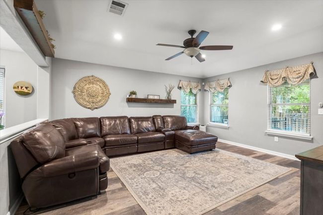 Living room featuring a ceiling fan, wood laminate floors, recessed lighting, and baseboards | Image 14