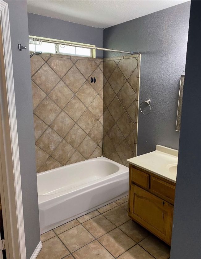 Full bathroom with vanity, tile patterned flooring, and shower combination | Image 20