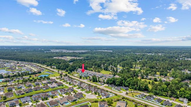 Aerial view of property and surrounding area with a heavily wooded area and nearby suburban area | Image 32