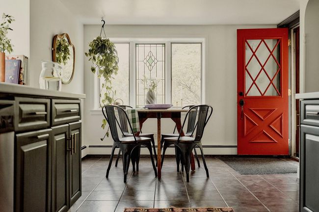 Dining space featuring dark tile patterned floors and baseboards | Image 4