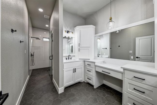 Bathroom with tile patterned flooring, vanity, and a shower with shower door | Image 8