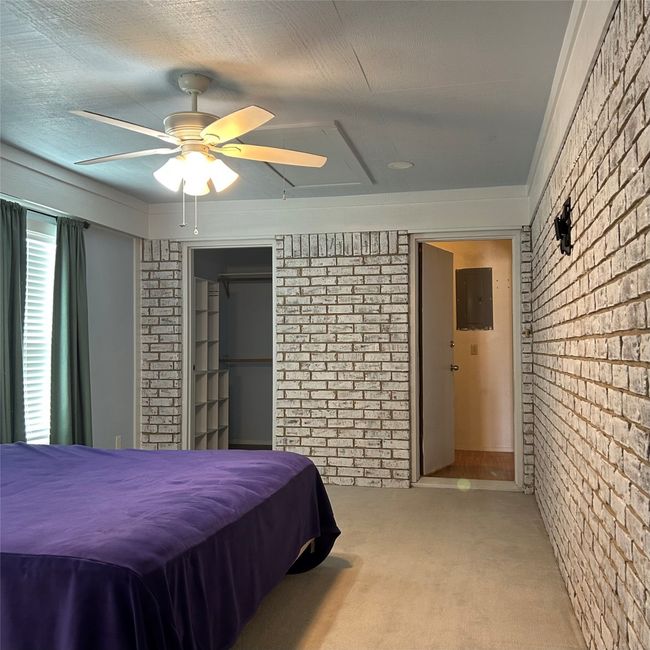 Unfurnished room featuring ornamental molding, an AC wall unit, a textured ceiling, wallpapered walls, and carpet floors | Image 15