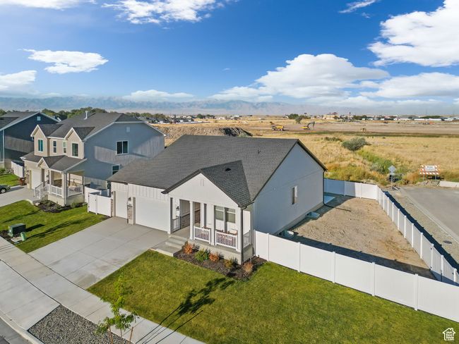 Modern farmhouse with roof with shingles, concrete driveway, a garage, fence private yard, and a front lawn | Image 6