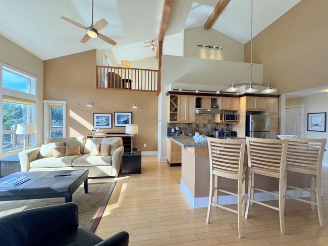 Living room featuring a ceiling fan, high vaulted ceiling, light wood-style flooring, and beam ceiling | Image 17