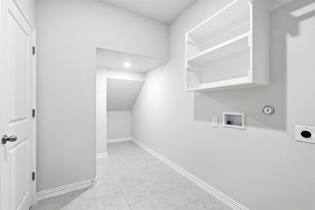 Laundry area with hookup for an electric dryer, gas dryer hookup, washer hookup, and marble look tiles | Image 27