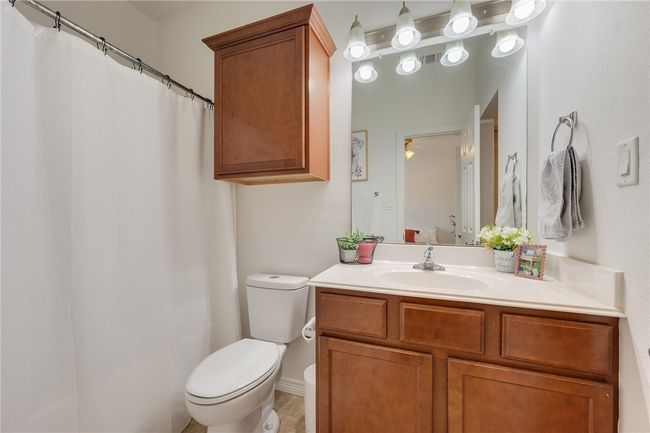 Bathroom featuring vanity, a ceiling fan, and curtained shower | Image 13