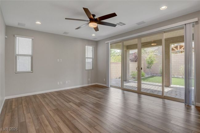 Empty room with ceiling fan, baseboards, wood finished floors, and recessed lighting | Image 21