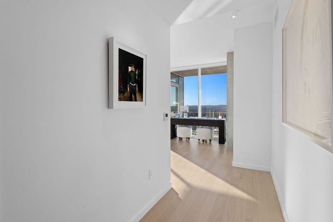 Corridor with light wood finished floors, expansive windows, and baseboards | Image 20