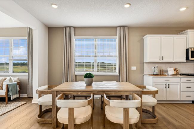 Photo is of the actual model. Soaked in natural sunlight, the homes eat-in dining room has ample space for a dining table located in the heart of the home. | Image 6