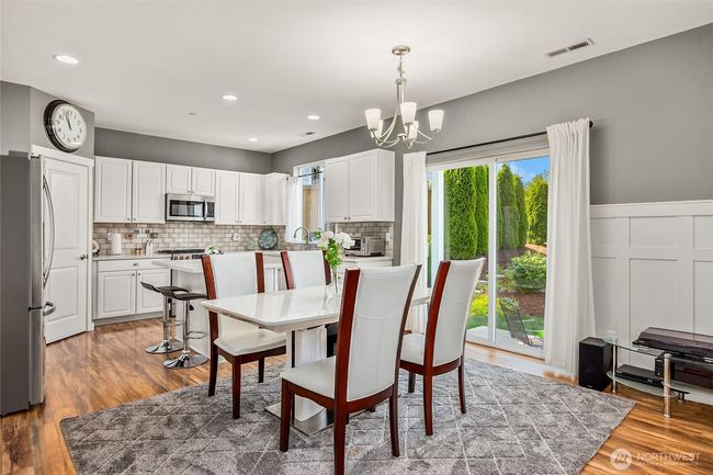 Dining room is ideal for entertaining and features a slider to backyard covered patio | Image 9
