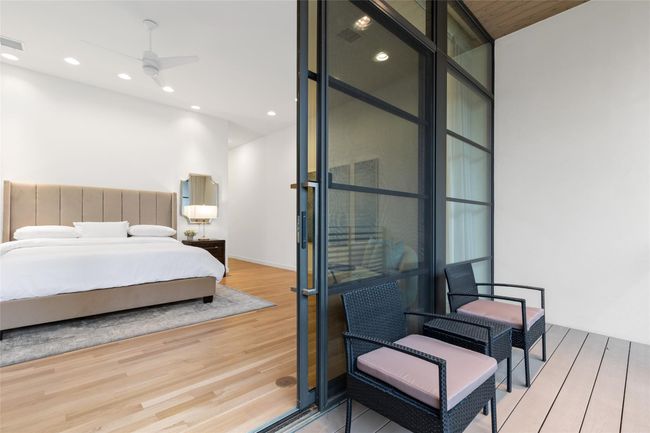 Bedroom with wood finished floors and recessed lighting | Image 17