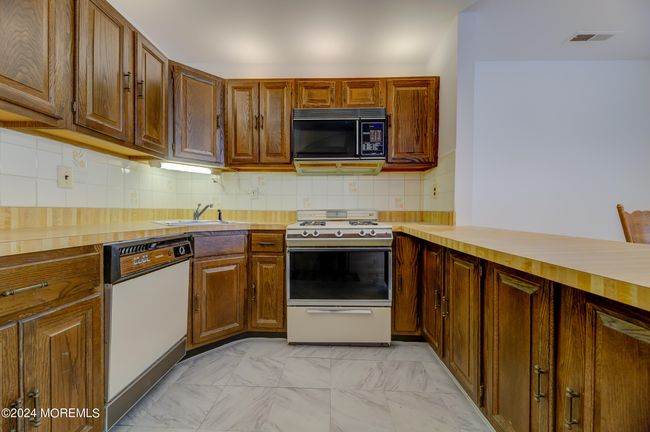 Spacious kitchen with plenty of counter space. | Image 7