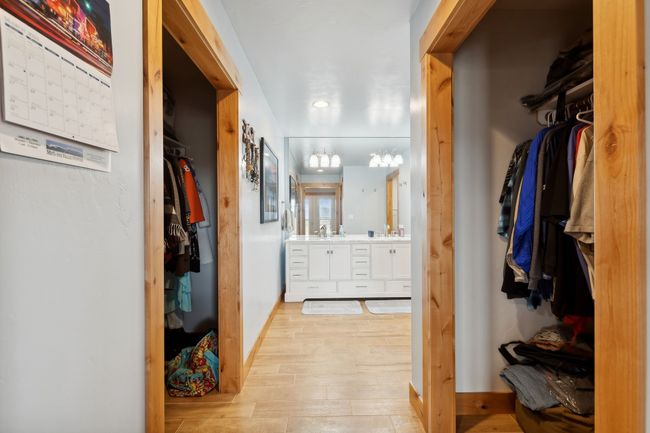 Spacious closet with sink and light wood-type flooring | Image 53