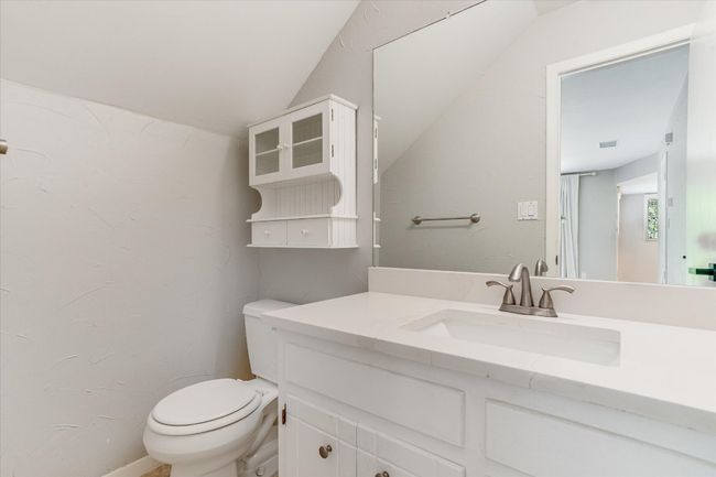 Half bath with vaulted ceiling, toilet, and vanity | Image 13