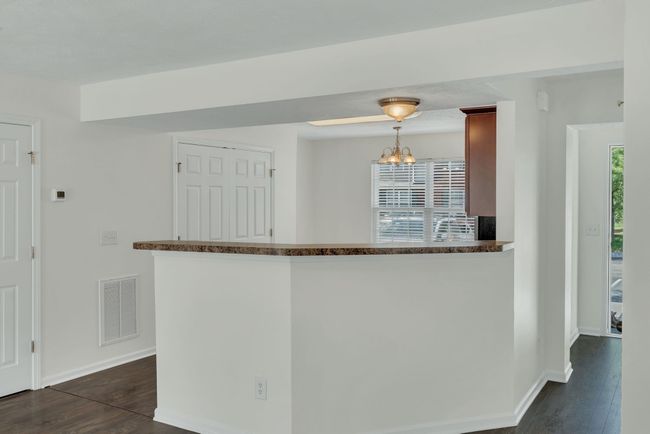 Kitchen is to the right of the foyer entrance. Notice the bar seating as well | Image 6