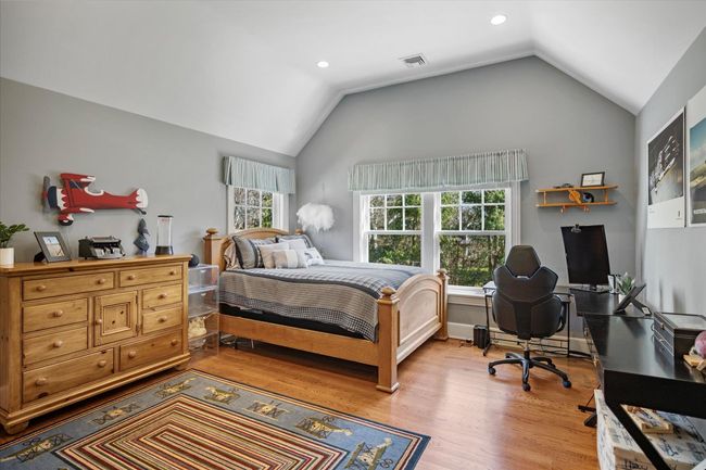 Bedroom featuring visible vents, recessed lighting, vaulted ceiling, and wood finished floors | Image 23