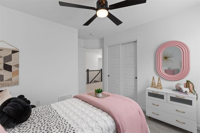 Carpeted bedroom featuring ceiling fan and a closet | Image 22
