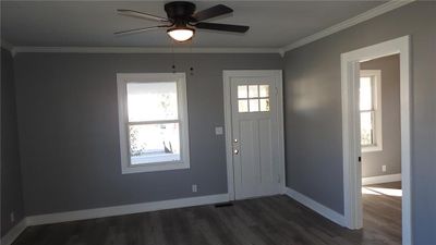 Foyer featuring crown molding, ceiling fan, and dark wood-type flooring | Image 3