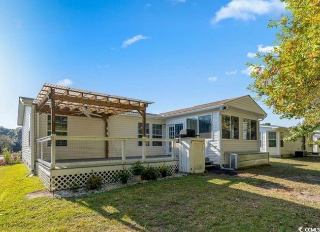 Back of house featuring a wooden deck, a pergola, and a yard | Image 27