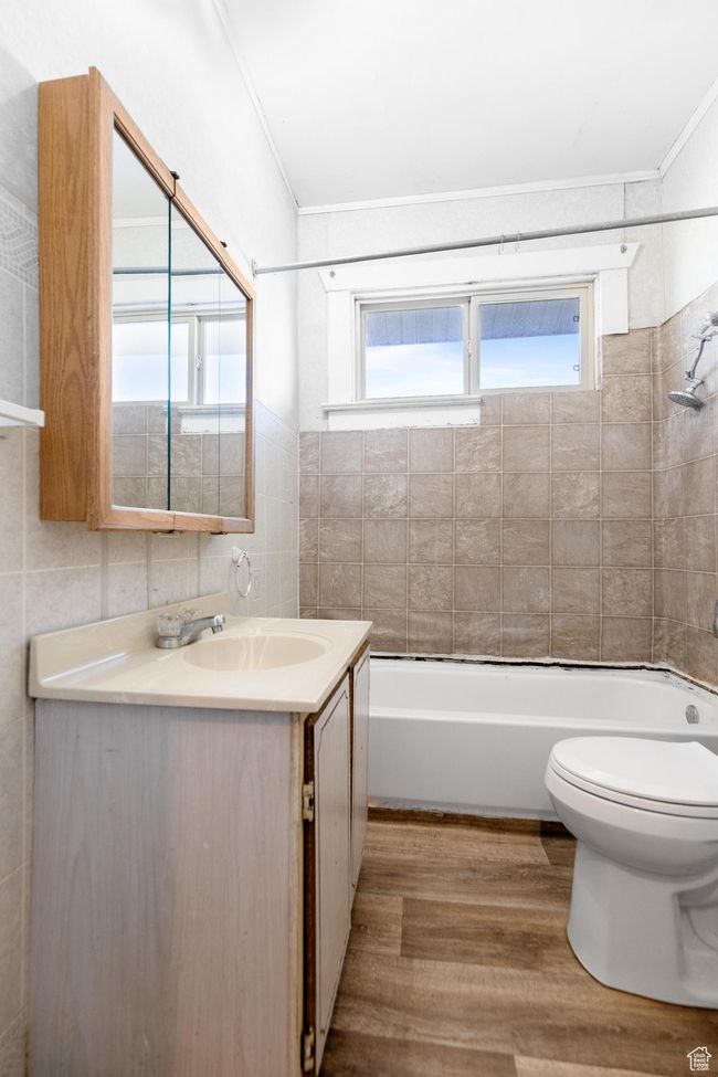 Bathroom with toilet, plenty of natural light, vanity, and wood finished floors | Image 16