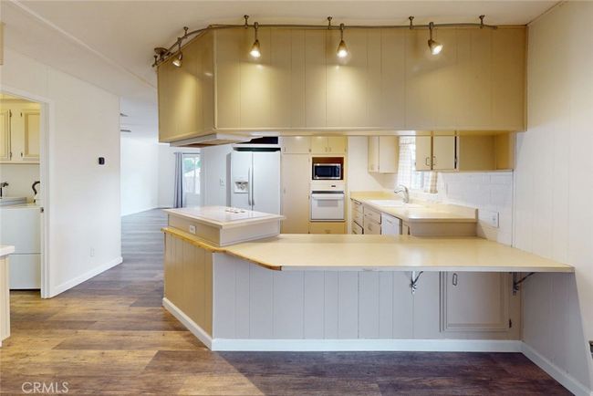 View from family room to kitchen. Laundry on the left. | Image 20