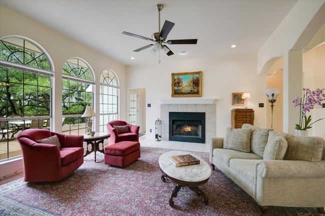 A cozy fireplace serves as the focal point of the living room, perfect for relaxing on warm evenings. | Image 5
