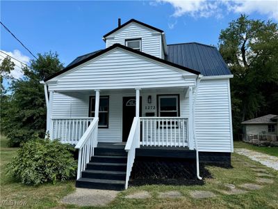 Bungalow-style house with a front yard and a porch | Image 1