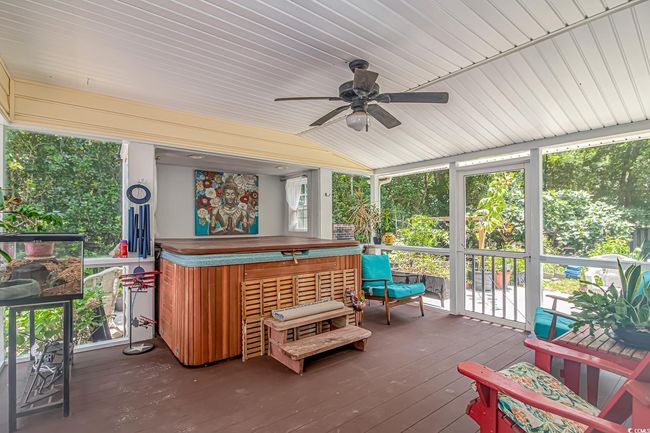 Sunroom featuring a hot tub, a ceiling fan, and lofted ceiling | Image 26