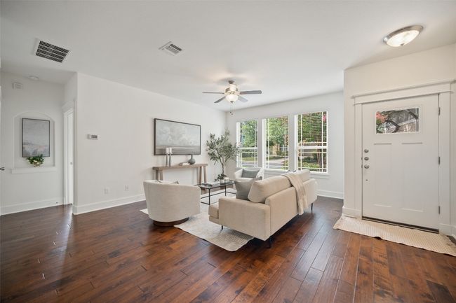The living room, with its expansive wall of windows, floods the space with natural light and offers an unobstructed view of the greenbelt, making it feel like the outdoors is right there with you | Image 6