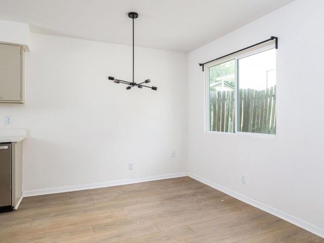 Unfurnished dining area with light wood finished floors and baseboards | Image 17