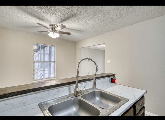 Kitchen featuring a ceiling fan and a textured ceiling | Image 19