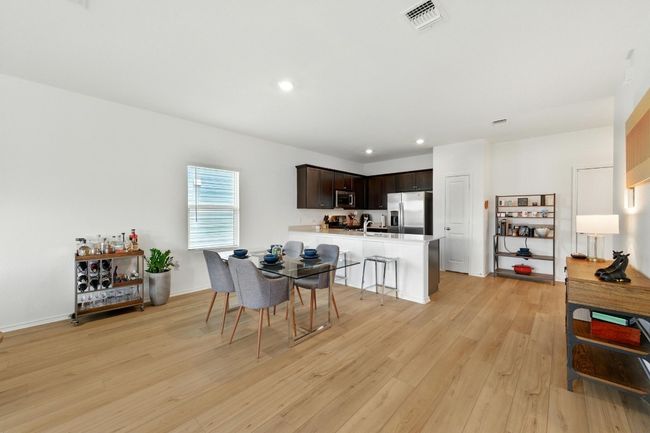 Dining space with light wood finished floors, recessed lighting, and baseboards | Image 8