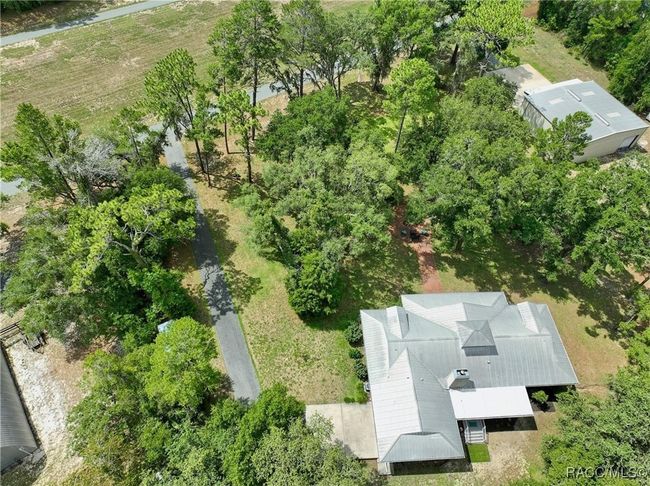 Aerial of home and hangar, driveway and front yard | Image 6