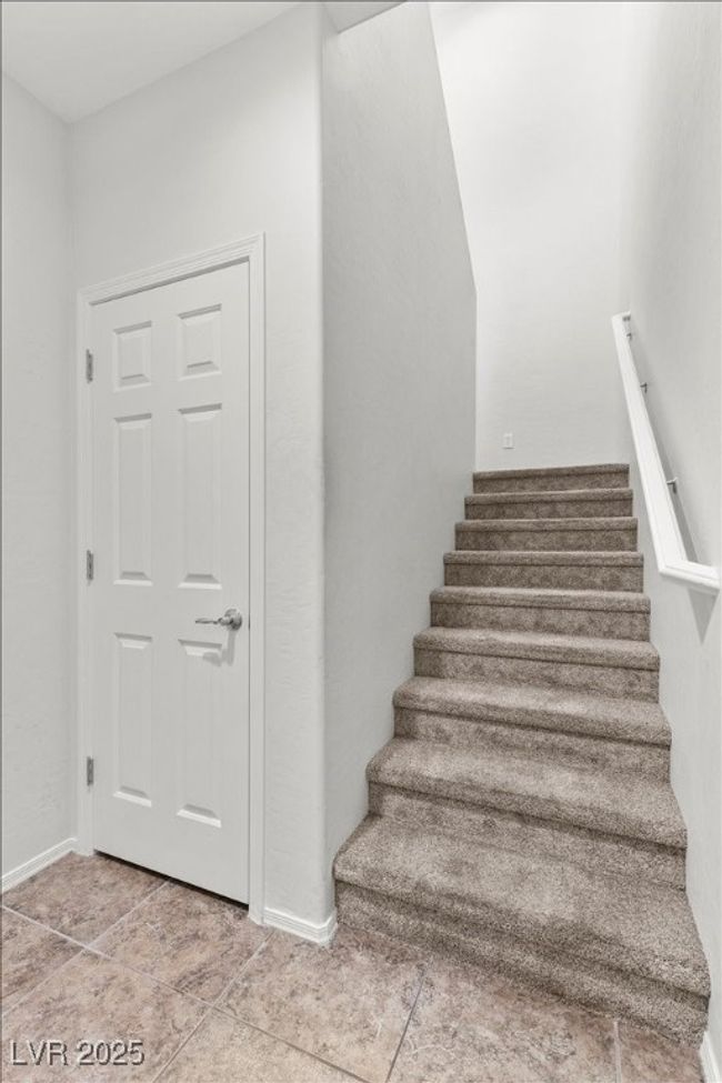 Stairs with tile patterned flooring and baseboards | Image 13