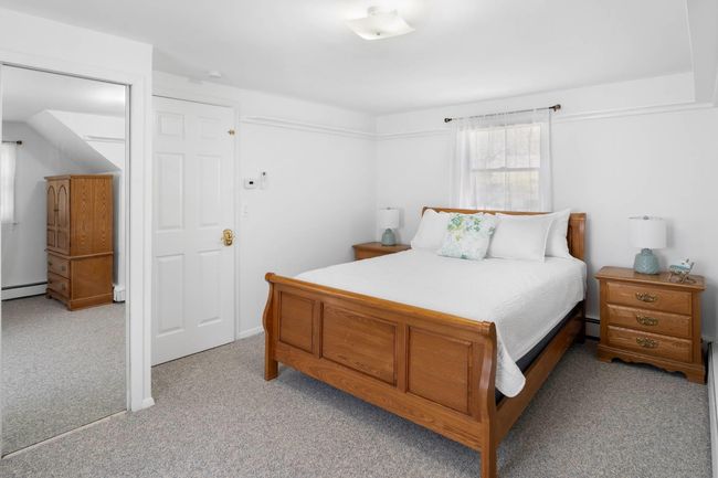 Carpeted bedroom featuring baseboard heating | Image 16