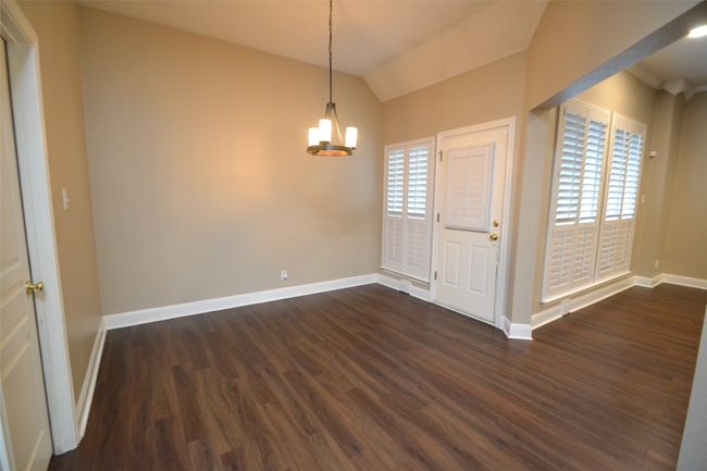 Entryway featuring a chandelier, dark wood-style flooring, healthy amount of natural light, and vaulted ceiling | Image 10