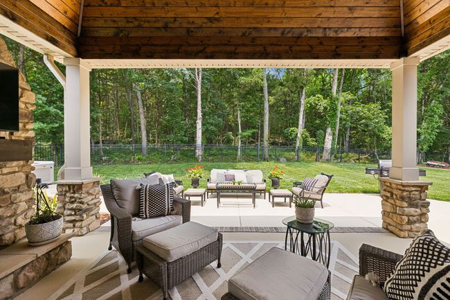 A Family Favorite! This back porch, patio and yard are what this family will miss the most! Serene and picturesque views of the surrounding wooded acreage... | Image 48