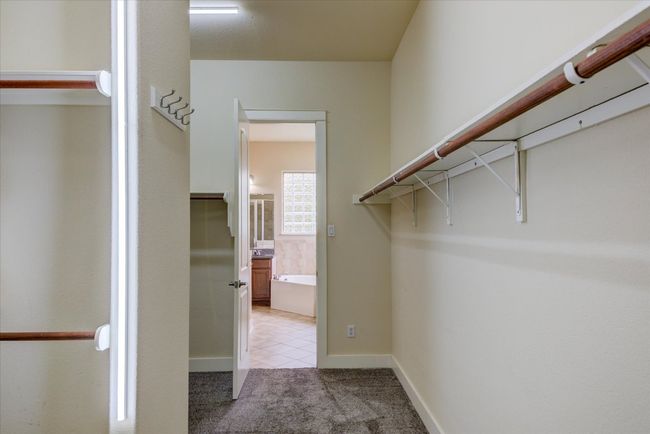 Huge walk-in closet with light colored carpet | Image 21