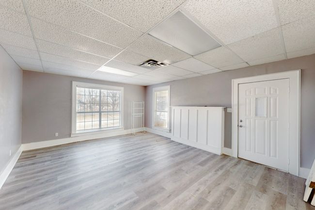 Unfurnished room with light wood-type flooring and a drop ceiling | Image 7