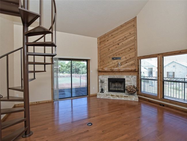 Stone wood-burning fireplace in the living room. | Image 5