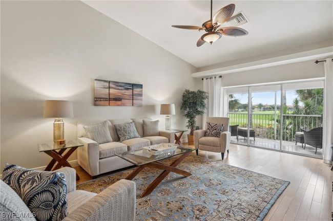 Living room featuring high vaulted ceiling, ceiling fan, and wood-type flooring | Image 7