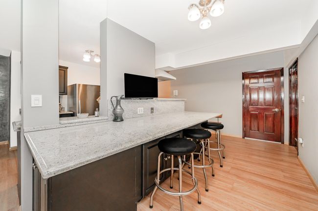 Kitchen featuring a breakfast bar | Image 5