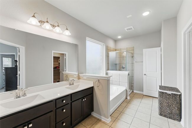 Full bathroom featuring a stall shower, a sink, visible vents, and tile patterned floors | Image 23
